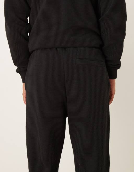 ASOS DESIGN – Schmal zulaufende Jogginghose in Schwarz mit gerippten Bündchen, Kombiteil, 5 von 5
