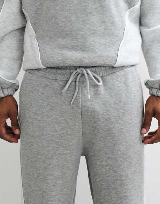 ASOS DESIGN schmal zulaufende Jogginghose mit Cut-and-Sew und Paspelierung in Grau-Meliert, 4 von 5