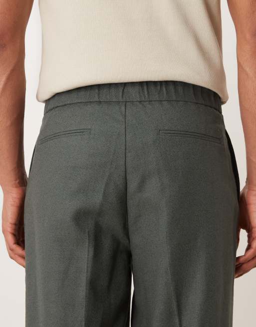 ASOS DESIGN – Schmal zulaufende Oversize-Anzughose aus gezwirntem Garn in Dunkelgrün, 4 von 5