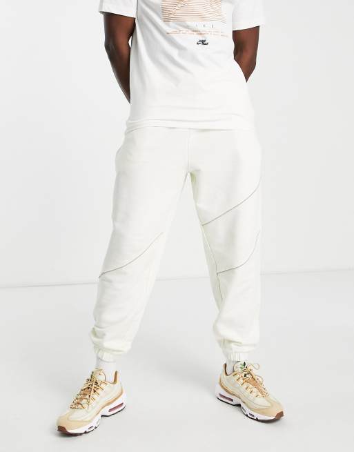 ASOS DESIGN – Schmal zulaufende Oversize-Jogginghose in farblich abgestimmtem Beige mit Paspelierung, Kombiteil
