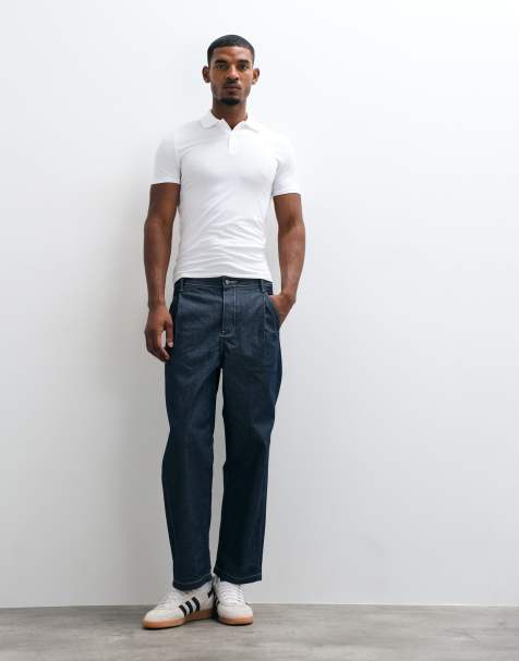 ASOS DESIGN – Schmal zulaufende Relaxed-Fit-Jeans aus Raw Denim mit Bundfalten und Schnalle - view 1