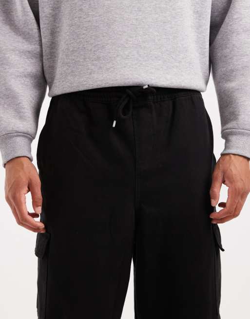 ASOS DESIGN – Schmal zulaufende Schlupf-Cargohose in Schwarz, 5 von 5