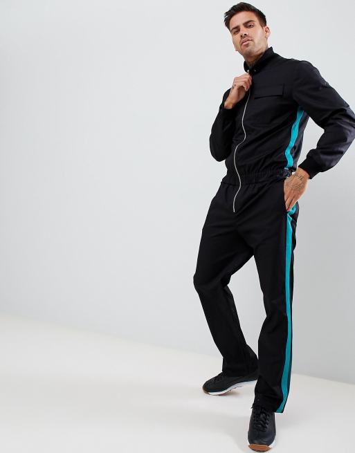 ASOS DESIGN – Schmaler, schwarzer Pilotenanzug mit grünem Zierband an