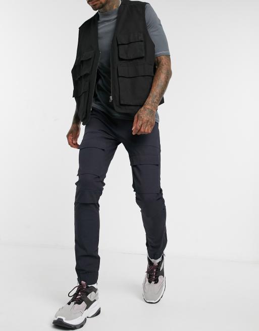 ASOS DESIGN – Schmalgeschnittene Cargohose mit Taschen an den Knien und Reißverschlüssen am Saum, Marineblau