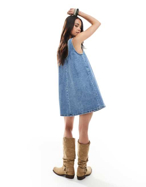 ASOS DESIGN scoop neck denim mini dress with bow detail in mid wash blue