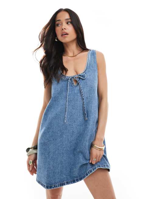 ASOS DESIGN scoop neck denim mini dress with bow detail in mid wash blue