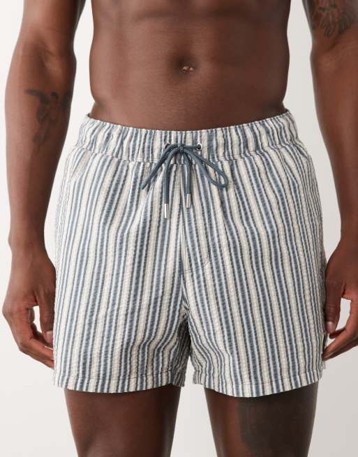 ASOS DESIGN seersucker stripe swim shorts in short length with badge in navy, 4 of 5