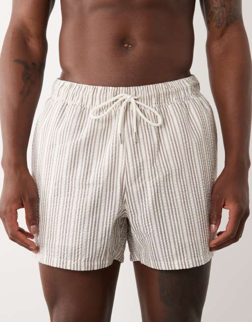 ASOS DESIGN seersucker striped swim shorts in short length in beige, 4 of 5