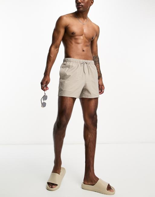 ASOS DESIGN seersucker swim shorts in short length in beige, 4 of 5