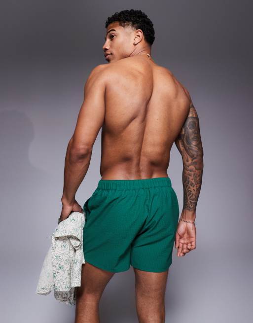 ASOS DESIGN seersucker swim shorts in short length in green
