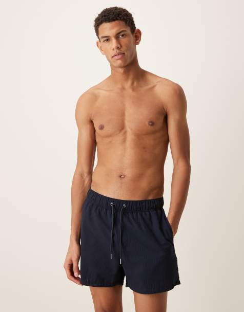 ASOS DESIGN seersucker swim shorts in short length in navy - view 1