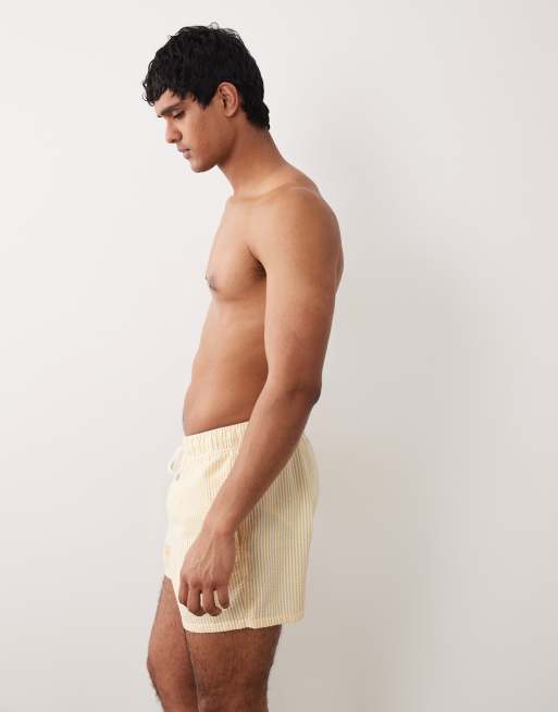 ASOS DESIGN seersucker swim shorts in short length in yellow stripe, 3 of 5