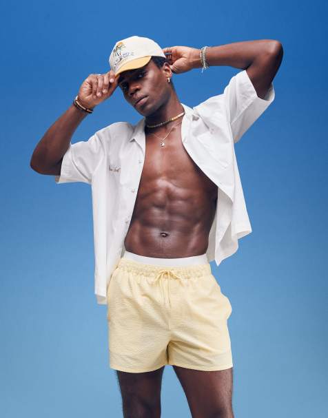 ASOS DESIGN seersucker swim shorts in short length in yellow - view 1