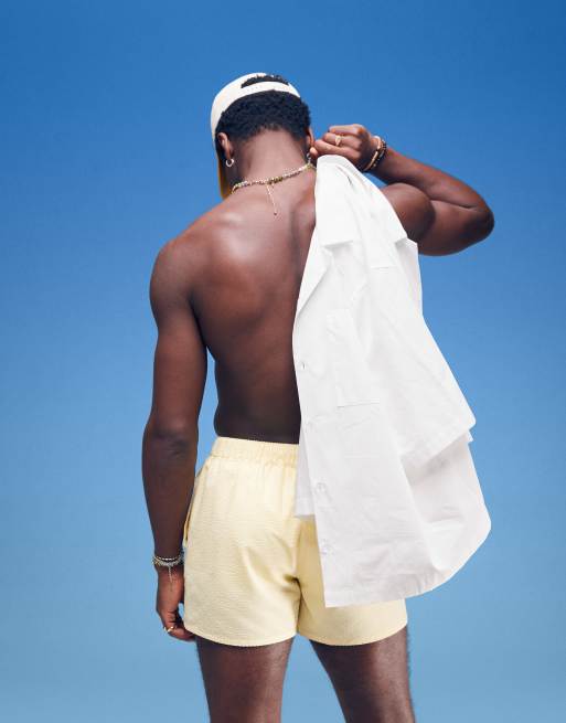 ASOS DESIGN seersucker swim shorts in short length in yellow 