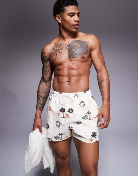ASOS DESIGN seersucker swim shorts in short length with palm tree print in neutral - view 1