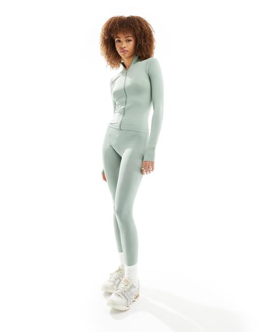 ASOS DESIGN – Set in Salbeigrün mit nahtlosem, langärmligem Oberteil mit Reißverschluss und Leggings