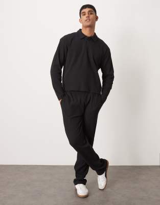 ASOS DESIGN – Set in Schwarz mit gerippter, gerade geschnittener Jogginghose und Polo-Sweatshirt - view 1