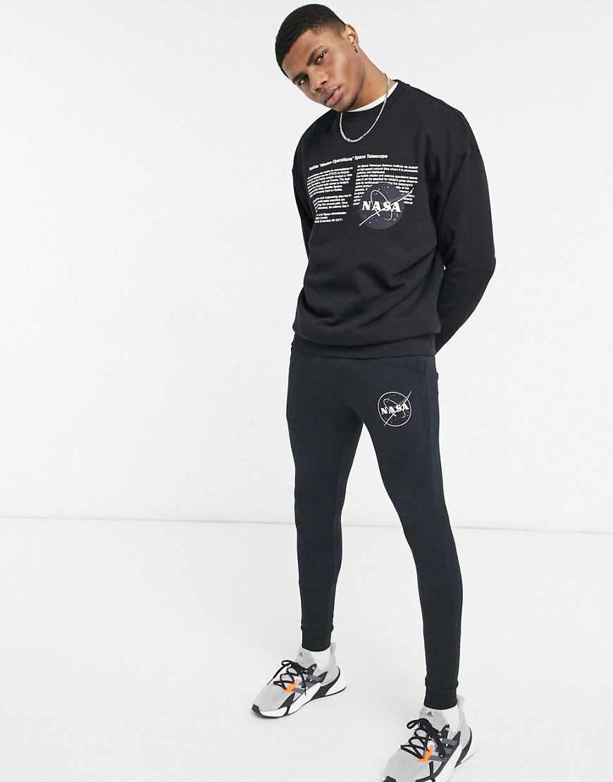 ASOS DESIGN set super skinny sweatpants with Nasa print in black