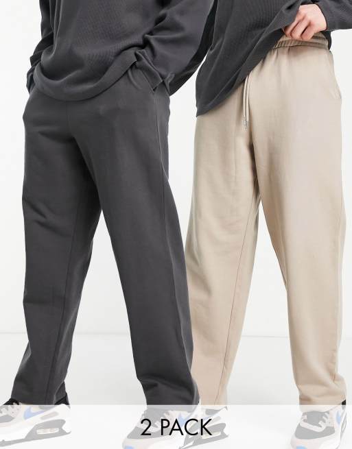 ASOS DESIGN - Set van 2 joggingbroeken met wijde pijpen in zwart en beige met wassing