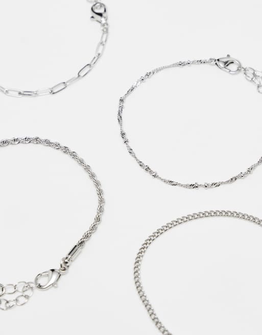 ASOS DESIGN - Set van 4 fijne schakelarmbanden in zilverkleur, 2 van 4