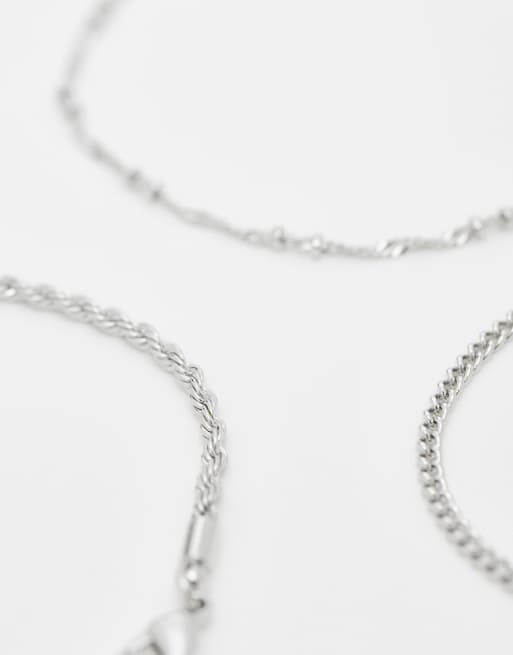 ASOS DESIGN - Set van 4 fijne schakelarmbanden in zilverkleur, 4 van 4