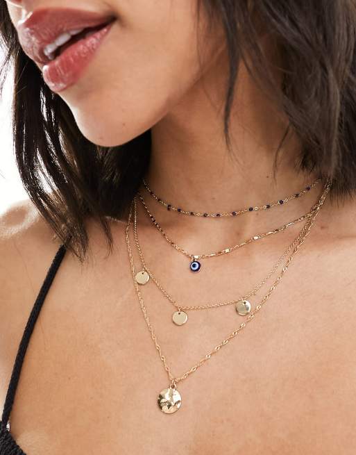 ASOS DESIGN - Set van 4 kettingen met schijf- en oogbedeltjes in goudkleur