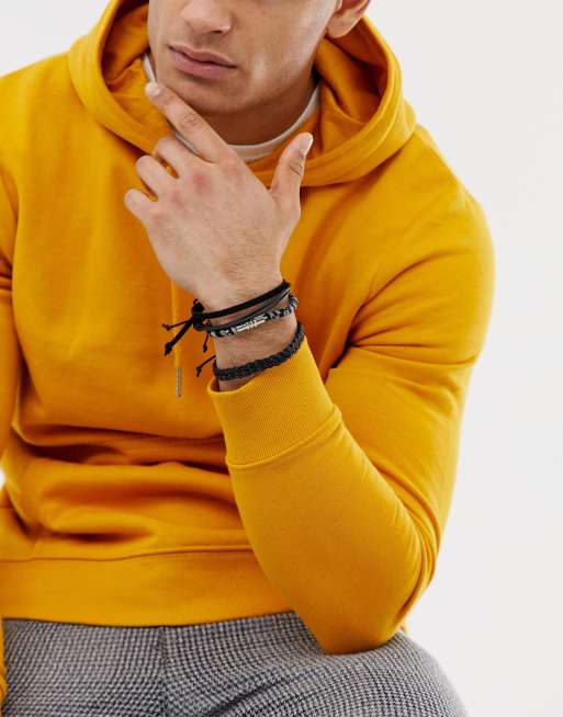 ASOS DESIGN - Set van 4 leren en geweven armbanden in zwart-wit, 3 van 4