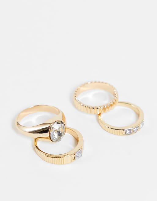 ASOS DESIGN - Set van 4 ringen met gegraveerde details en siersteentjes in goudkleur
