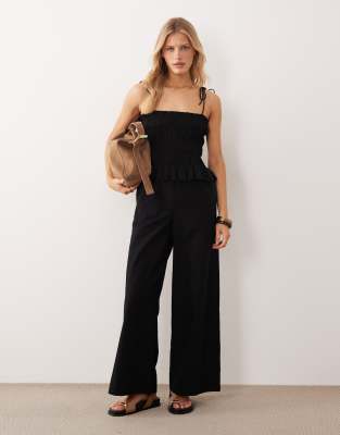 shirred peplum waist jumpsuit in black