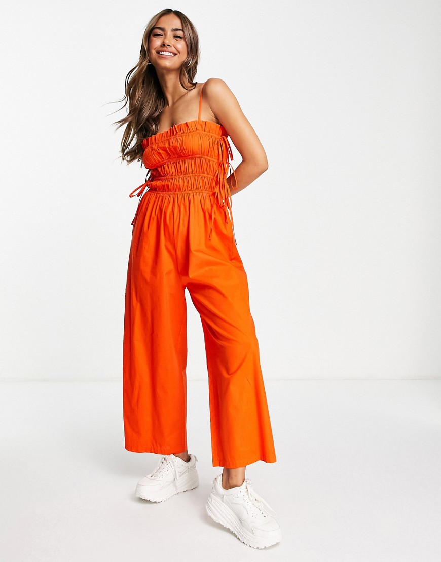ASOS DESIGN shirred strappy jumpsuit with tie side detail in red