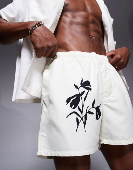 ASOS DESIGN short length swim shorts with floral print in cream