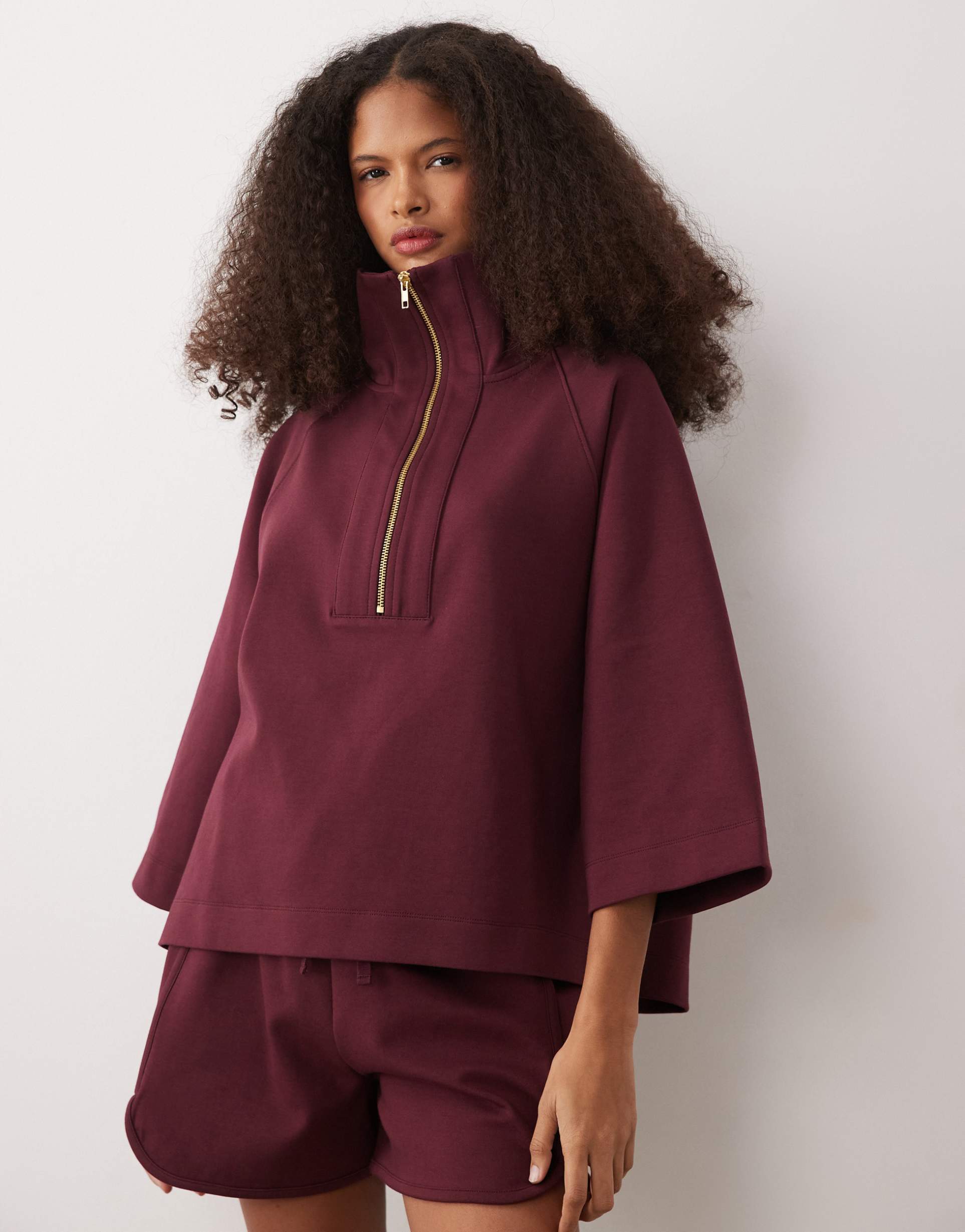 asos design short sleeve with zip detail top in burgundy in scuba-style fabric