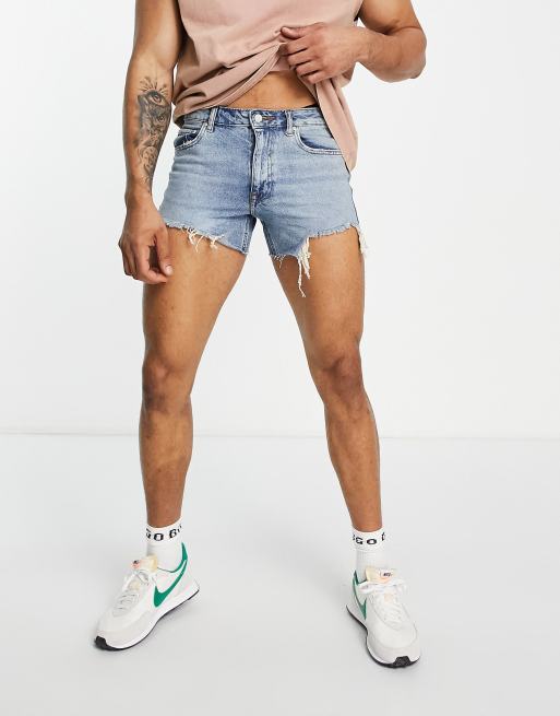 ASOS DESIGN shorter length denim shorts in 90s mid wash with rip