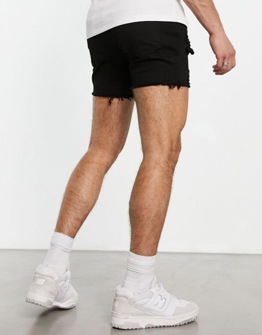 ASOS DESIGN shorter length denim shorts in mid wash with heavy rips