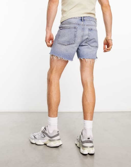 ASOS DESIGN shorter length denim shorts with rips in light wash