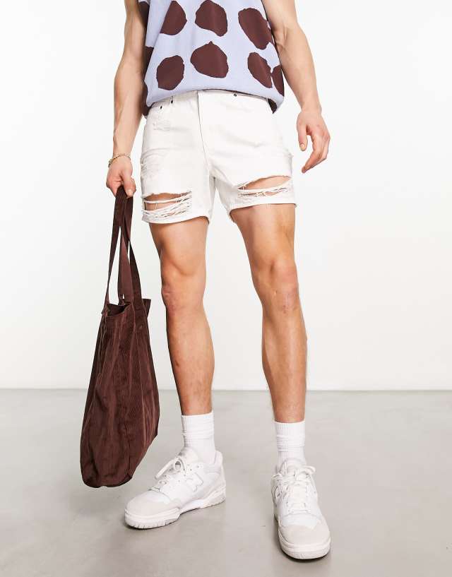 ASOS DESIGN shorter length denim shorts with rips in white