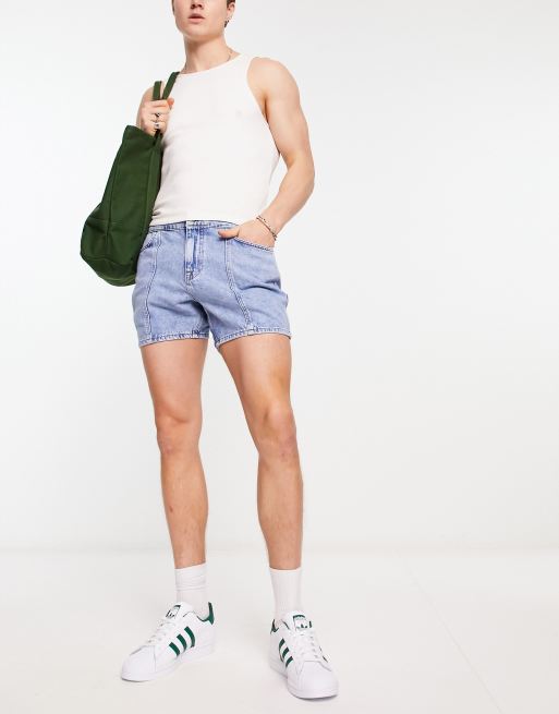 ASOS DESIGN shorter length denim shorts in 90s mid wash with rip detail and  raw hem