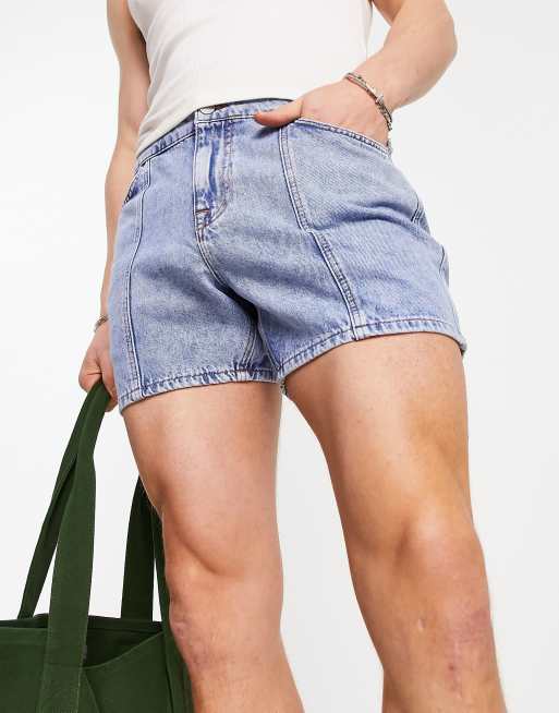 ASOS DESIGN stretch mid length denim shorts in flat mid wash blue