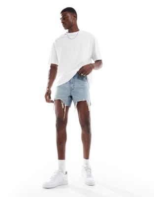 shorter length slim denim shorts in mid wash blue with rip details