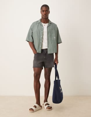 ASOS DESIGN shorter length slim denim shorts with rip detail in black