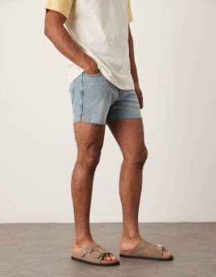 ASOS DESIGN shorter length slim denim shorts with rip detail in light wash blue