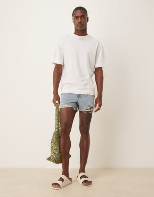 ASOS DESIGN shorter length straight fit denim shorts with rip detail in light wash blue