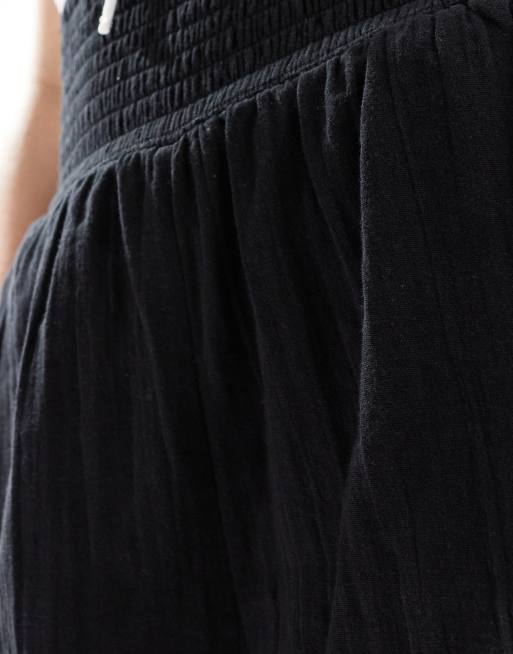 ASOS DESIGN shorts with elasticated waist in textured cotton in black, 4 of 5