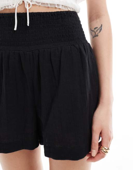 ASOS DESIGN shorts with elasticated waist in textured cotton in black, 5 of 5