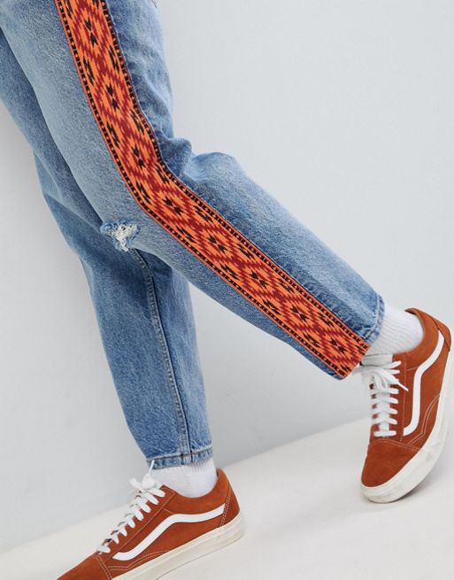 ASOS DESIGN skater jeans in vintage mid wash with orange geo-tribal side  stripe