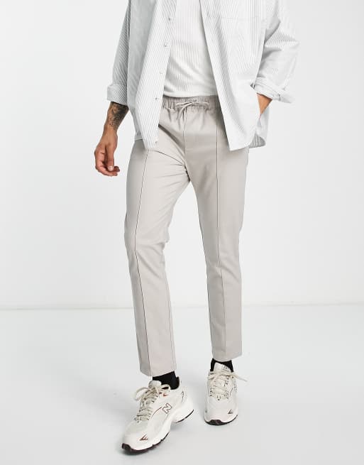 ASOS DESIGN - Skinny chino's met platgestikte plooitjes en elastische taille in stone