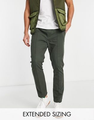 ASOS DESIGN skinny chinos with pin tuck and elastic waist in dark green