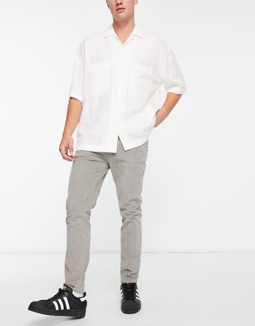 ASOS DESIGN skinny cord pants in charcoal with snow wash