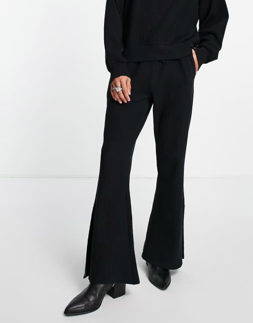 ASOS DESIGN skinny flared trackies with side split in black rib (part of a set)