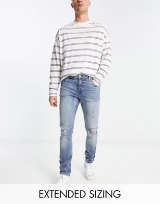 ASOS DESIGN skinny jean in mid wash with rips